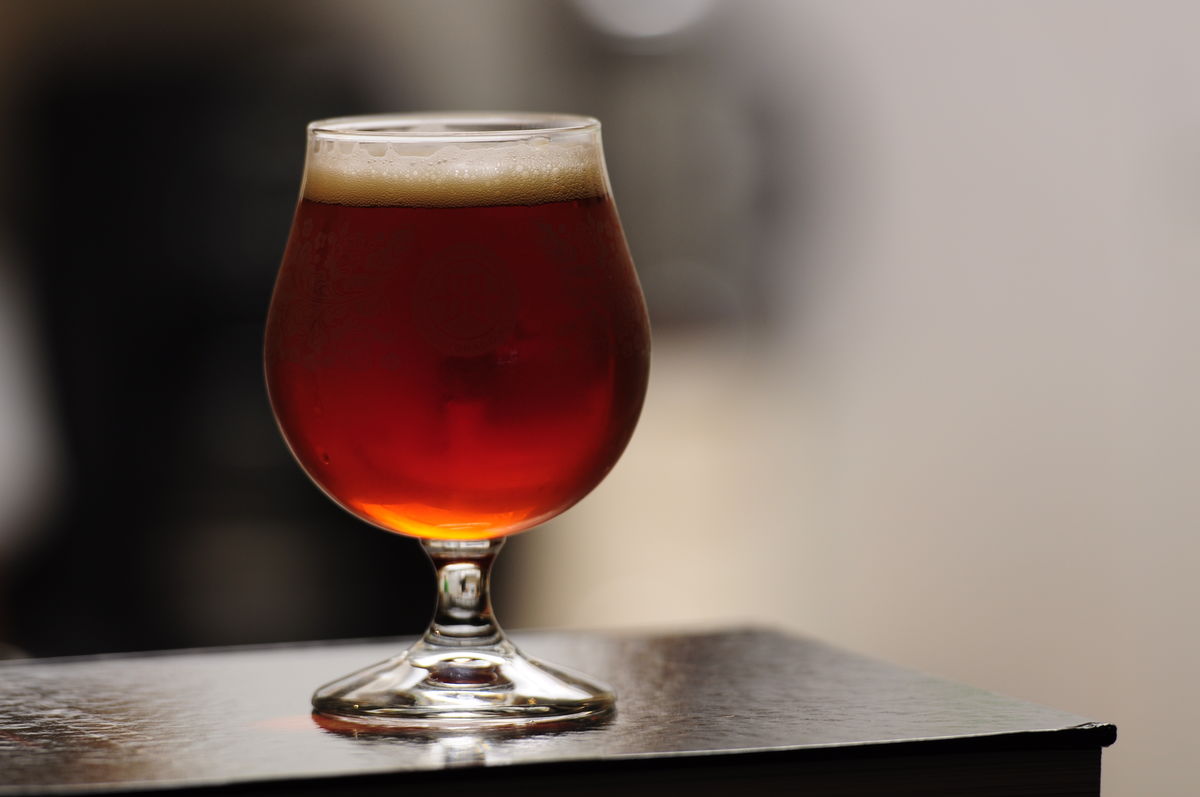 snifter glass full of amber-colored beer