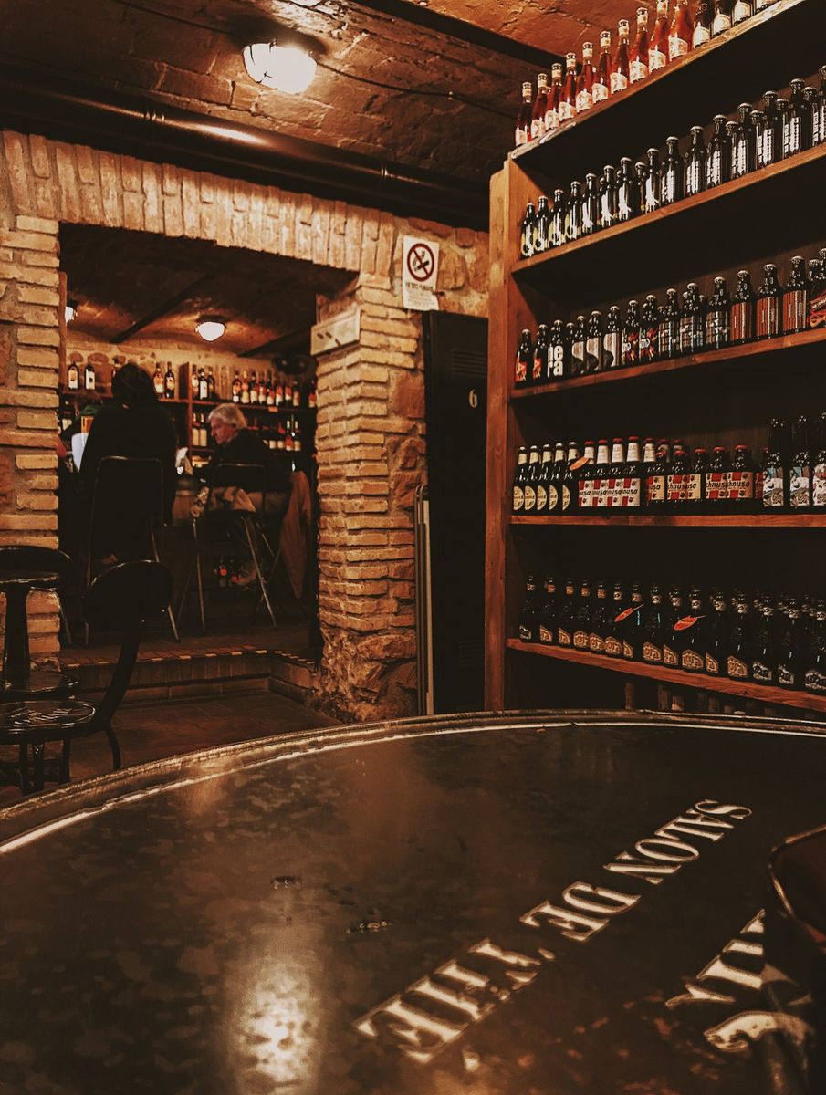 Bottles shelved for aging in a beer bar.