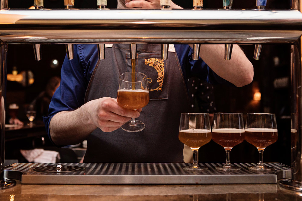 Bartender pouring a beer at Band of Bohemia