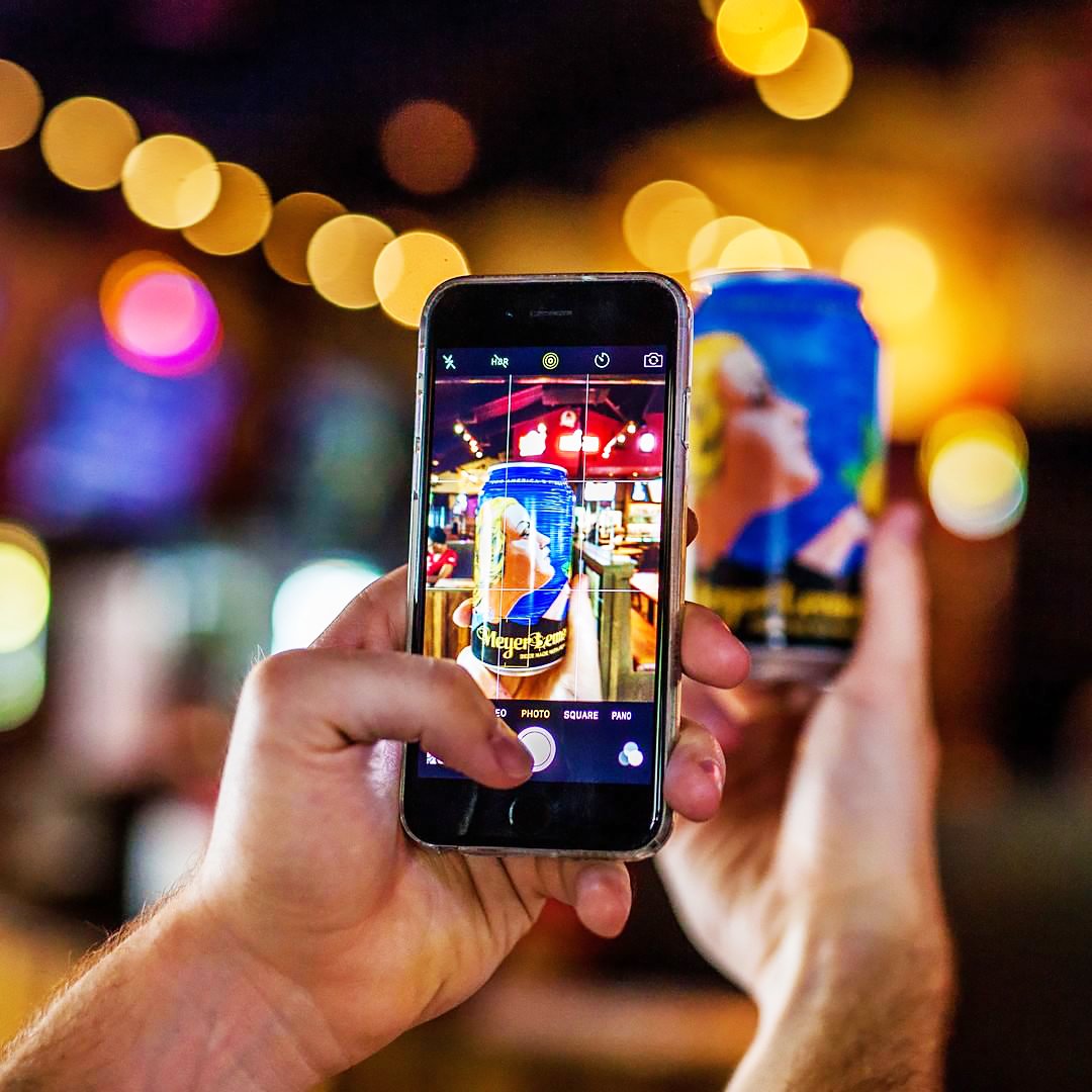 person photographs anchor meyer lemon lager on an app