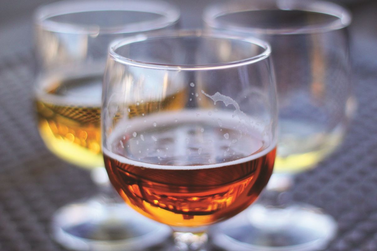 half-full beer glasses with beer foam