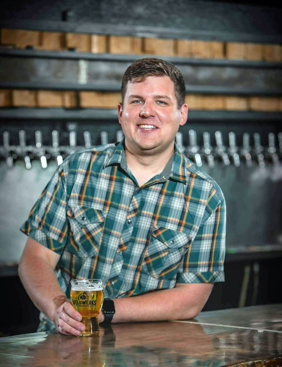 patrick combs stands in front of weldwerks tap handles